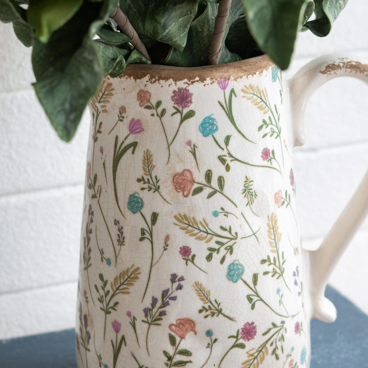 Ceramic Pitcher Vase with Floral Motif and Textured Rim